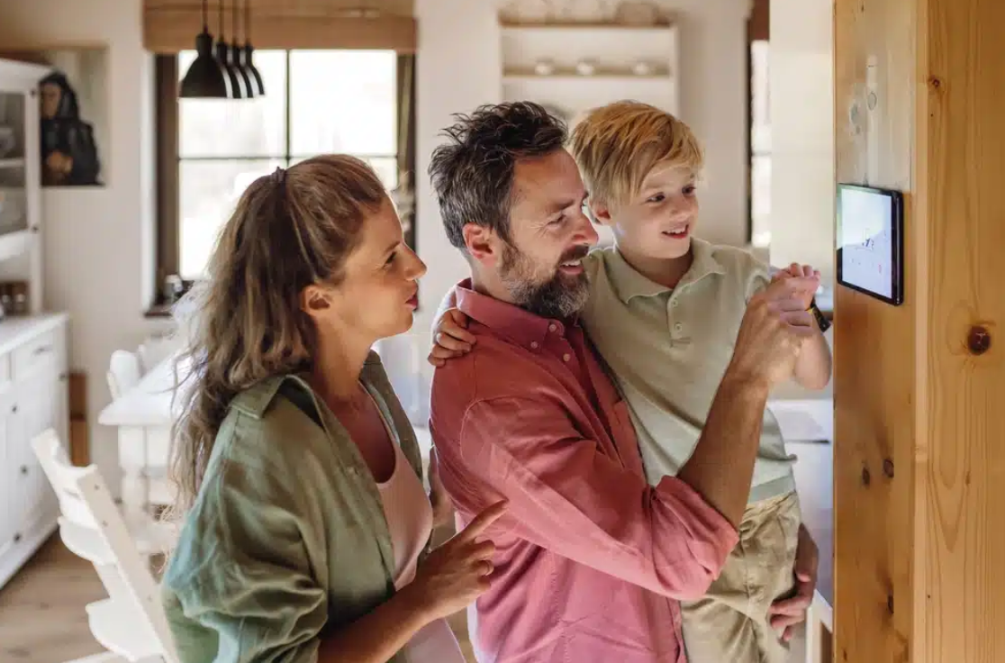 Thermostat Family using a smart thermostat to adjust temperature in their home